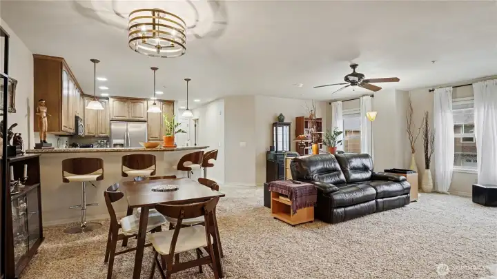 From this angle, the open-concept design seamlessly connects the living room, dining area, and kitchen, creating a warm and welcoming space for gatherings.