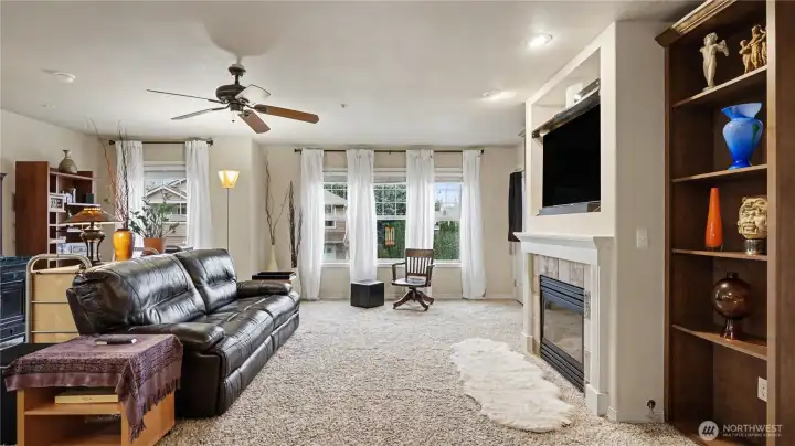 Generous living room featuring large windows that flood the space with natural light and warmth.