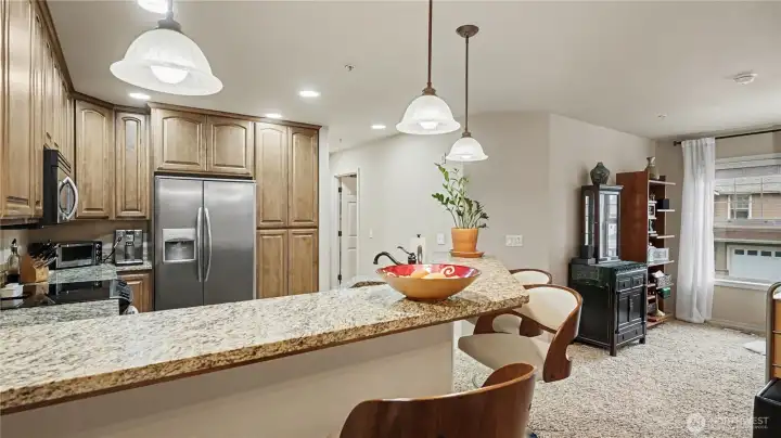 View of the peninsula seating highlights a functional and social kitchen layout.