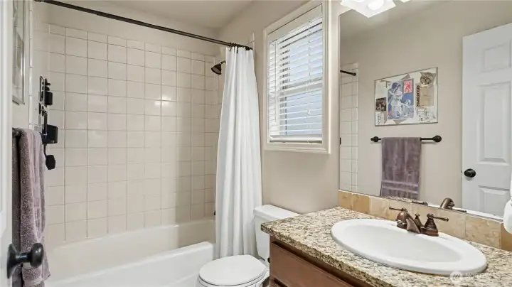 Main bathroom with ample counterspace and neutral color palate.