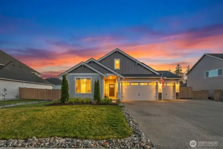 From this angle, the full width of the home and driveway comes into view, offering generous off-street parking and easy access. The manicured lawn and stone accents add to the home’s curb appeal. From this angle, the full width of the home and driveway comes into view, offering generous off-street parking and easy access. The manicured lawn and stone accents add to the home’s curb appeal.