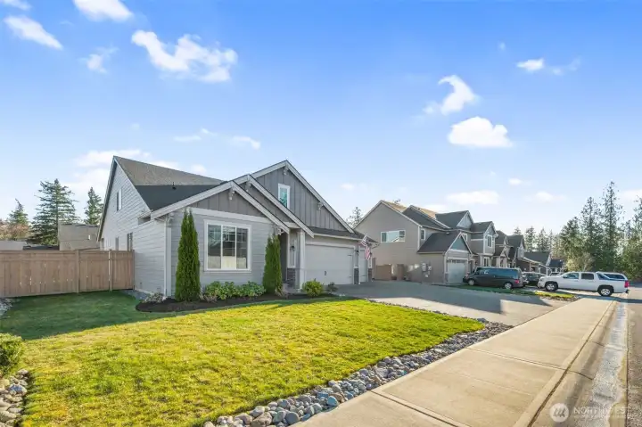 Positioned along a quiet residential street, this home showcases a wide lot frontage, sidewalk access, and a well-kept neighborhood setting. The exterior design blends seamlessly with surrounding homes.