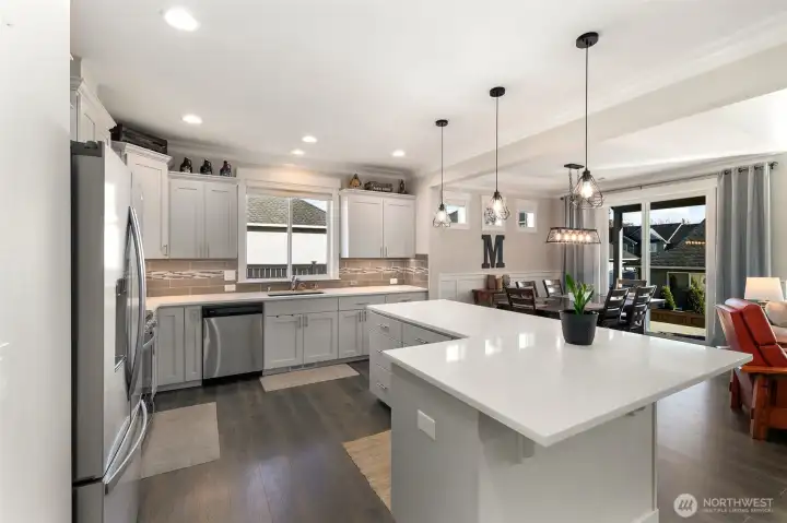 Clean and functional kitchen layout with plenty of counter space and storage, all centered around a bright window that brings in natural light.