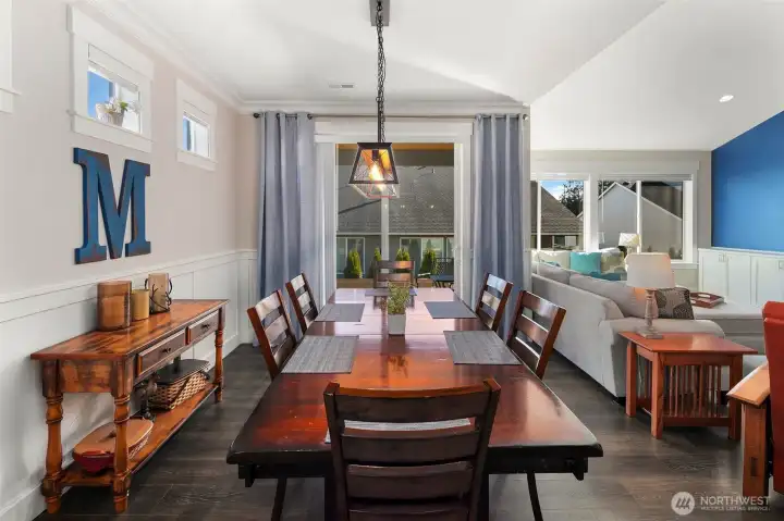 The dining area sits just off the kitchen, creating an easy flow for meals and gatherings, with direct access to the outdoor patio beyond.