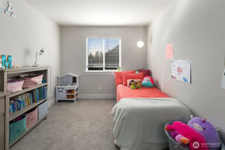 From this angle, the room feels bright and open, with a large window bringing in natural light and space to play or relax.