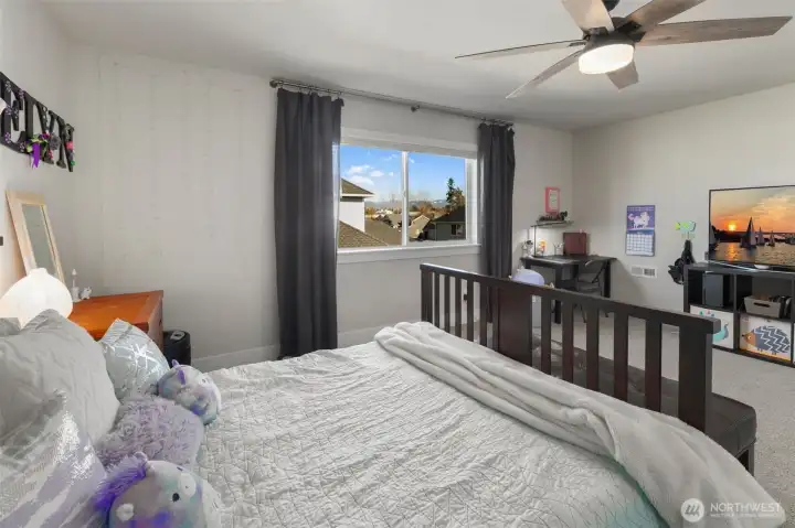 Another view of the bedroom shows flexible space for a desk or reading nook, making it easy to adapt as needs change.