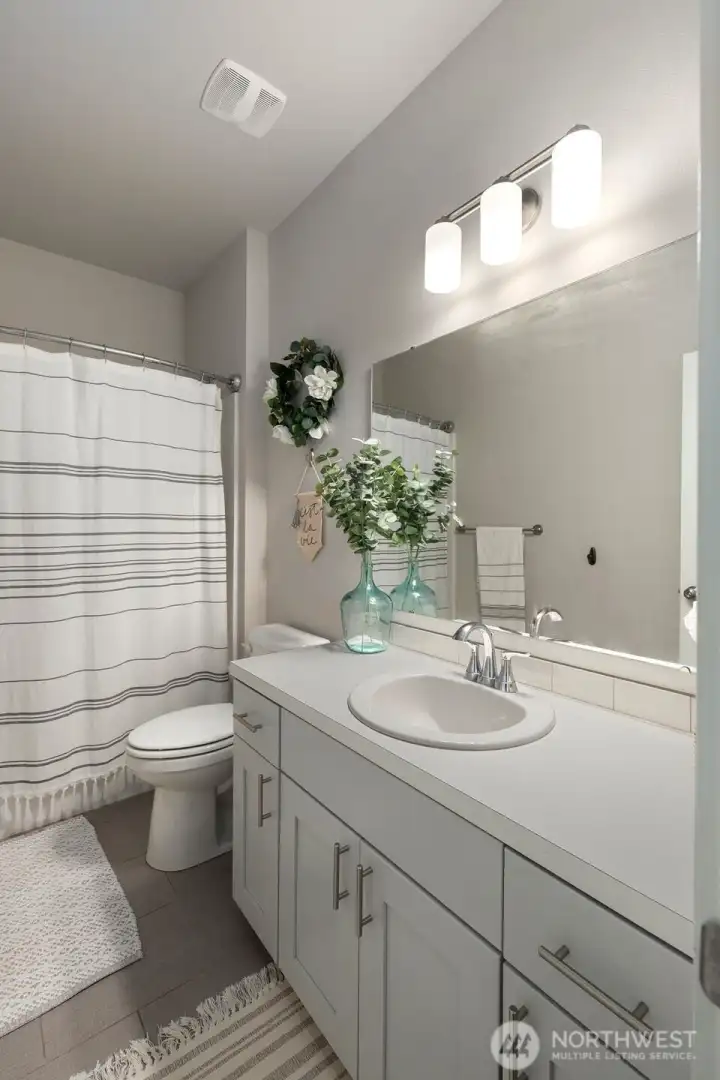 Bright and clean bathroom with a long vanity and plenty of counter space for everyday use.