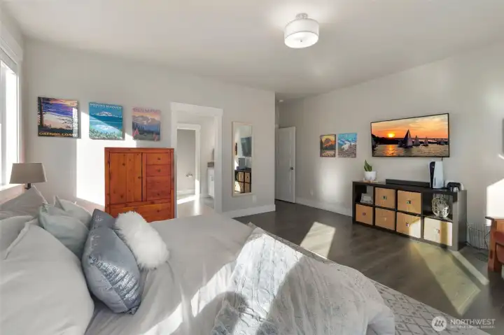 Another view of the primary suite, showcasing its open layout and comfortable seating area.