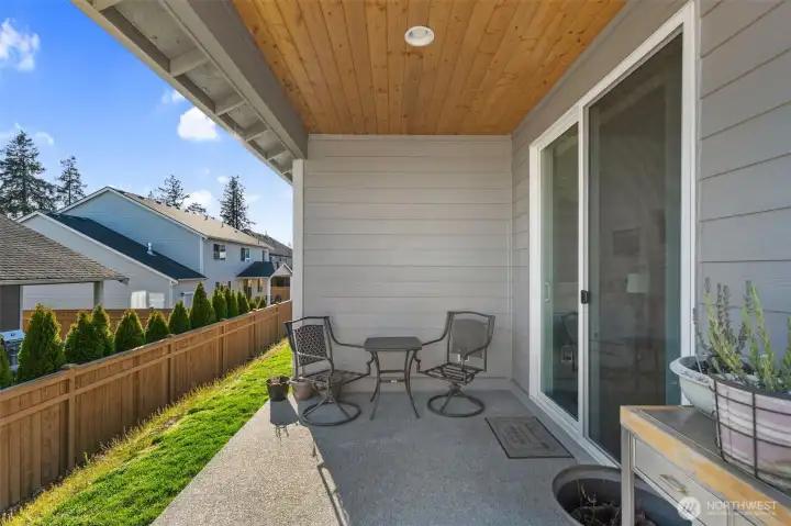 Covered outdoor patio ideal for morning coffee or evening unwinding, overlooking a fully fenced yard.