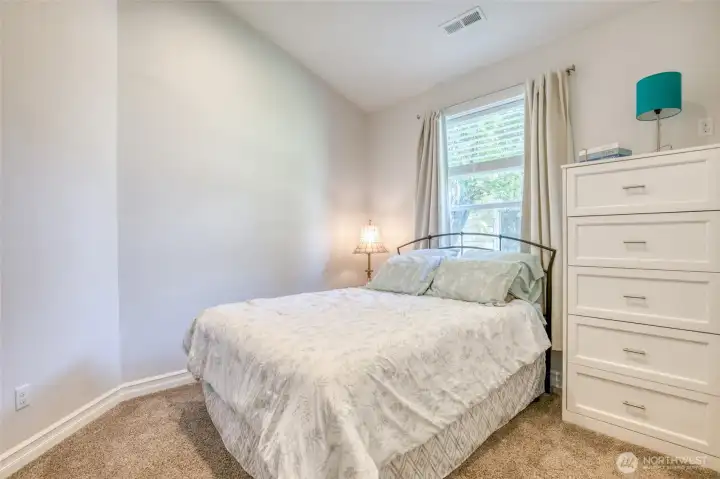 Quiet rear bedroom with natural light and a comfortable layout.