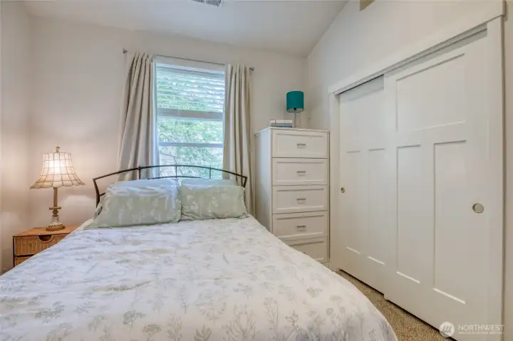 Custom built-in dresser and closet system add smart, organized storage to the rear bedroom.