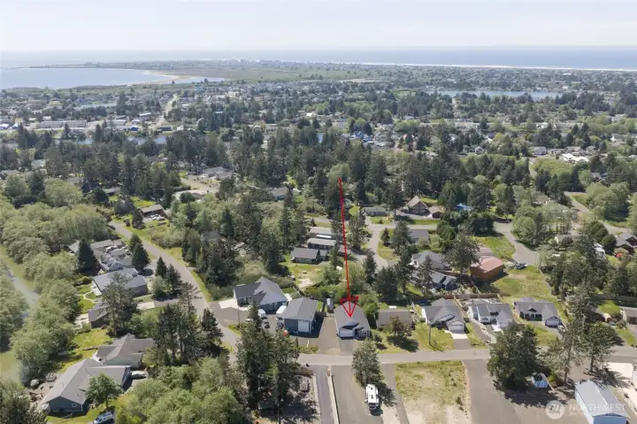 Established neighborhood view of home, looking toward the Oyhut wildlife estuary and nature preserve