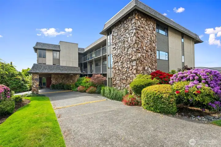 Welcoming circular drive with covered entry and secure access to lobby with elevator.