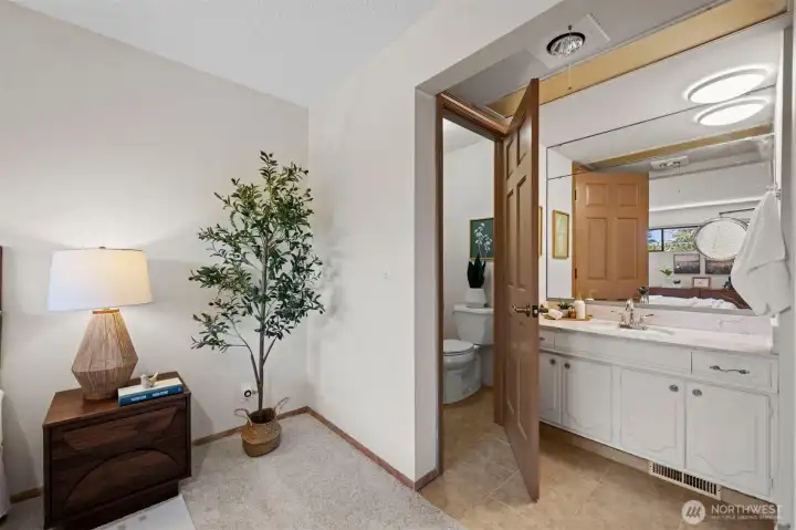 En-suite primary bath with separate toilet room and plenty of counter space.
