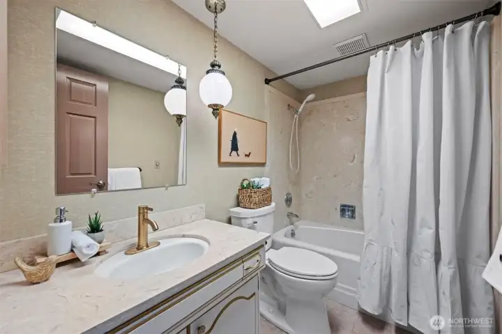 Full size hall bath with new fixtures and toilet. Located just off the second bedroom.