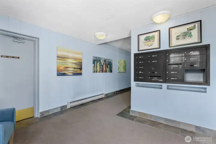 Secured entry lobby with indoor mailboxes and elevator.
