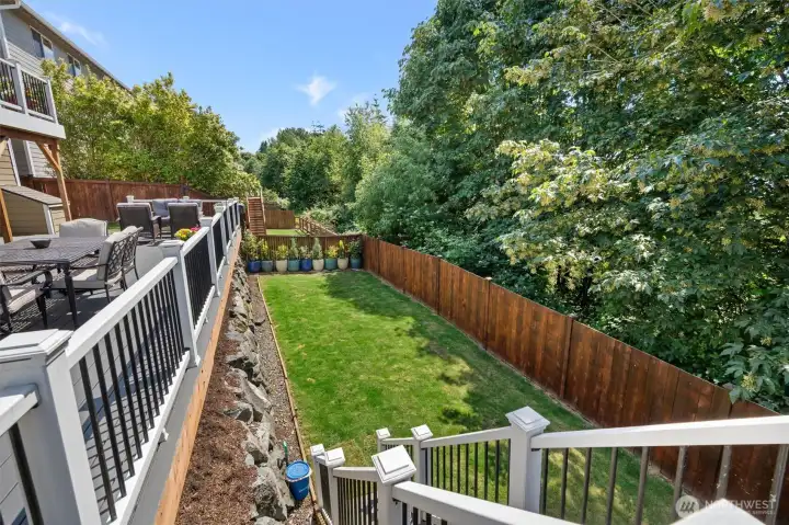 Large level yard with retaining wall.