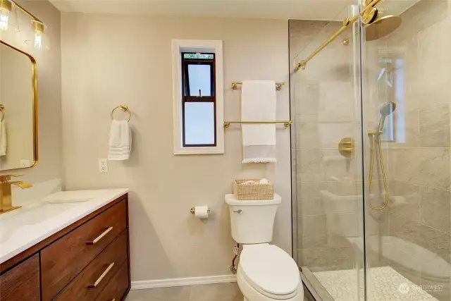 Newly remodeled primary bathroom with lovely, tiled shower, new glass shower door, fixtures and vanity!