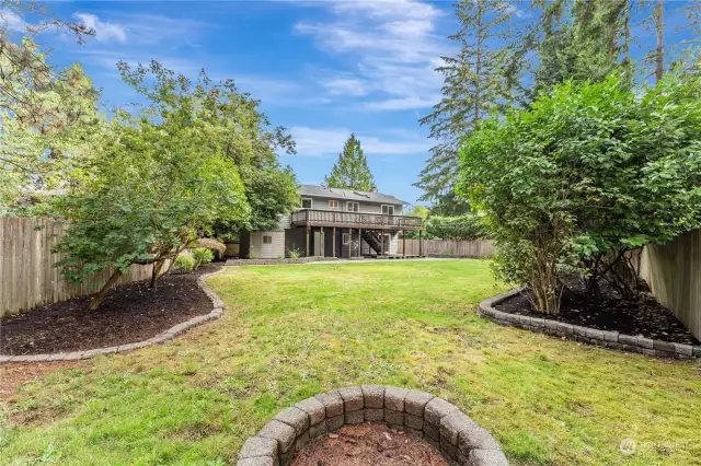 Wonderful oversized backyard with fire pit, and level grass to enjoy a wild game of croquet, or set up a badminton net for outdoor fun.