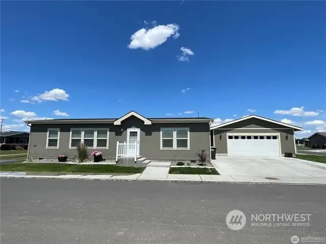 Corner lot with 2 additional parking spaces on left side of home.