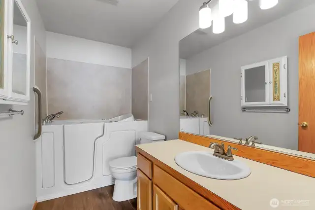 Convenient walk in tub located off of primary bedroom