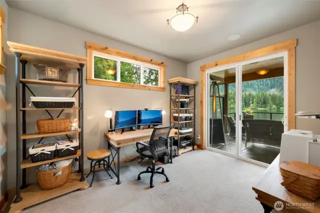 Den on main floor, with sliding door leading to concrete tile deck