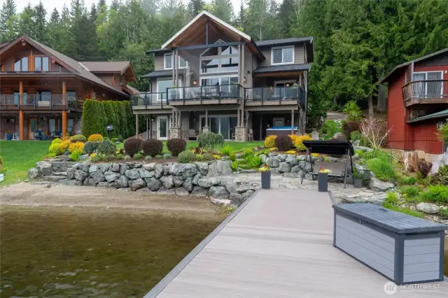 Your own beach and beautiful stone bulkhead, with stone steps leading to the manicured yard.