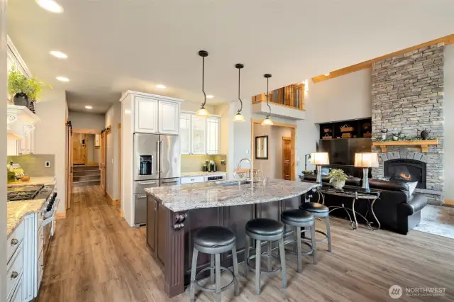 Kitchen looing towards great room and down the hallway to 2 pantries, laundry room and garage entrance