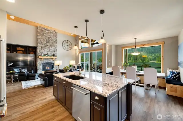 Kitchen to dining to great room, leading to the double slider and deck