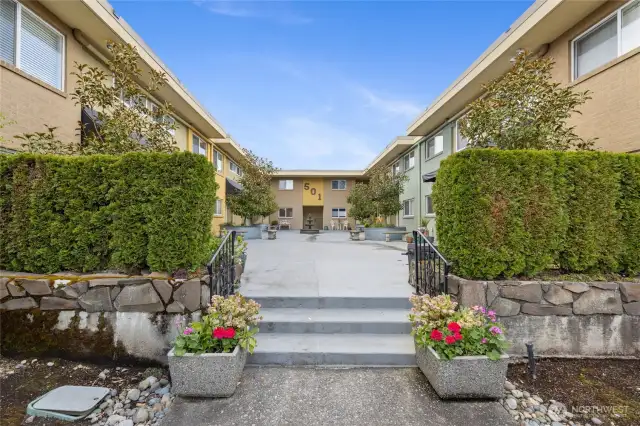 A couple steps up to courtyard entry.
