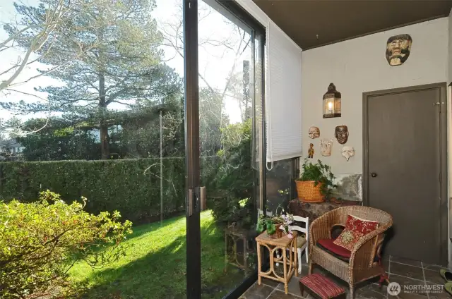 Sunroom that captures the morning sun and opens onto serene garden space. The floor to ceiling blinds provide privacy and shade. Archive photo.