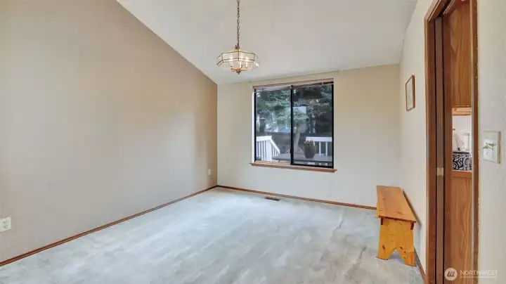 Formal dining room with vaulted ceilings.