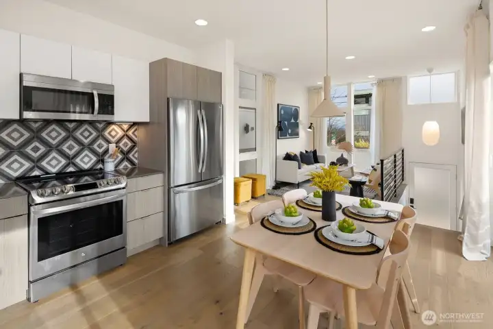 Looking from chef's kitchen and dining area toward living and entry.