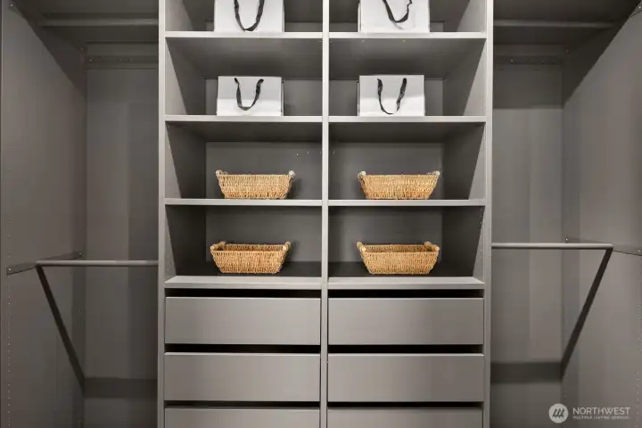 Beautifully organized with custom cabinetry and accent lighting, this walk-in closet is finished in designer colors for a polished look.