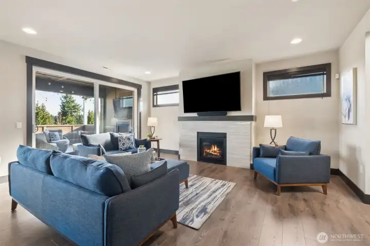 WOW, large windows, gorgeous flooring, fresh paint, massive tiled gas fireplace and the huge mounted TV stays!