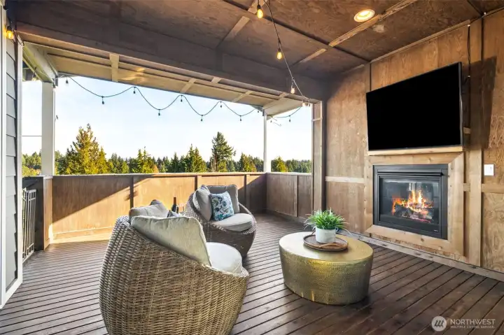14’x16’ covered deck of the living & dining rooms includes a cozy outdoor fireplace & attached TV that stays and a gas BBQ hookup for entertaining!