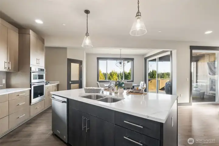 Oversized island, pendant lighting, and easy access to outdoor living—perfect for entertaining.