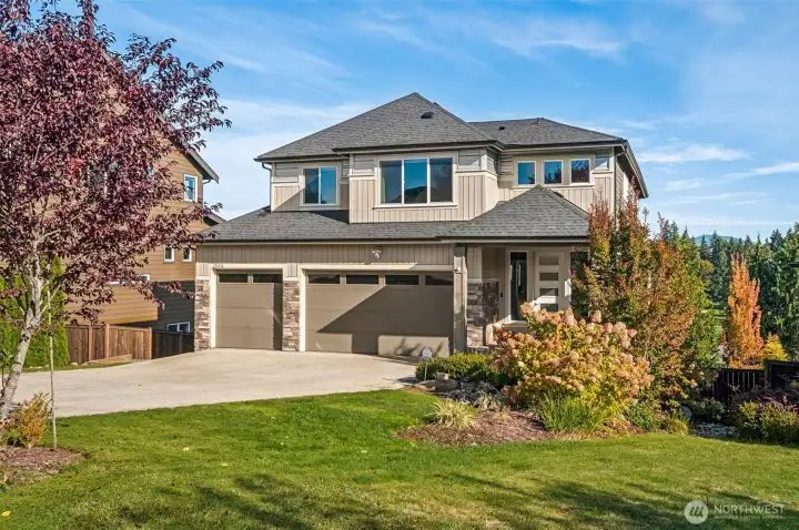 Stunning exterior with manicured landscaping, expansive driveway, and impressive curb appeal.