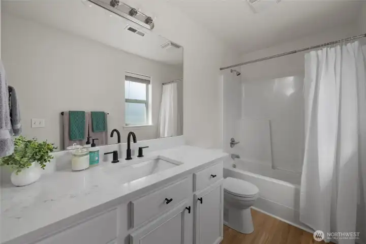 Upstairs full bathroom with quartz countertop and LVP flooriong.