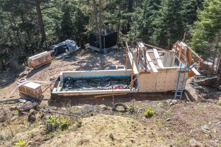 Greenhouse foundation started and ready for completion by buyer.