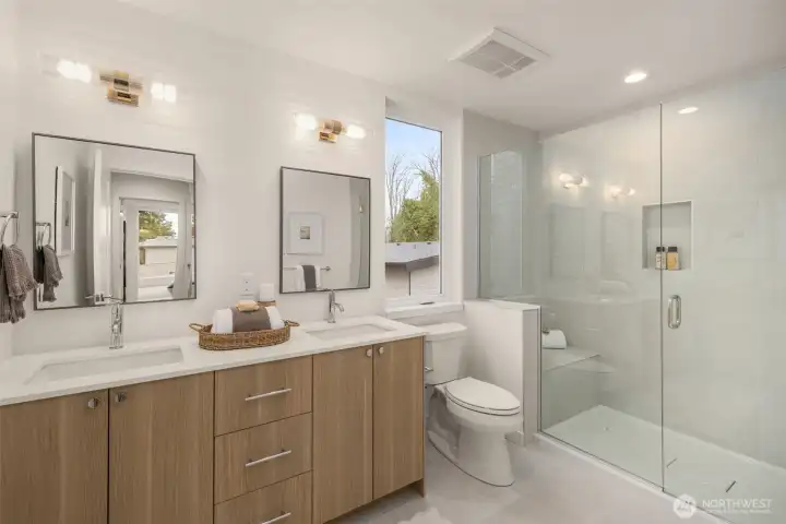 The spa-inspired primary bath features a dual-sink vanity, floating cabinets, and high-end tile work for a five-star experience