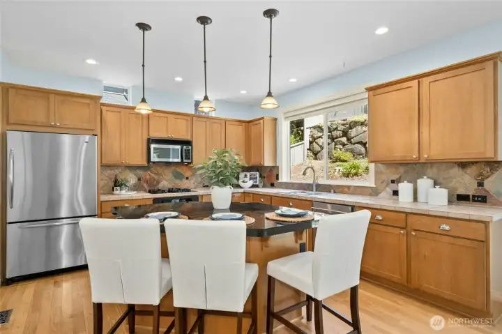 Spacious kitchen with center island, new LED recessed lighting throughout, walk-in pantry and stainless steel appliances.