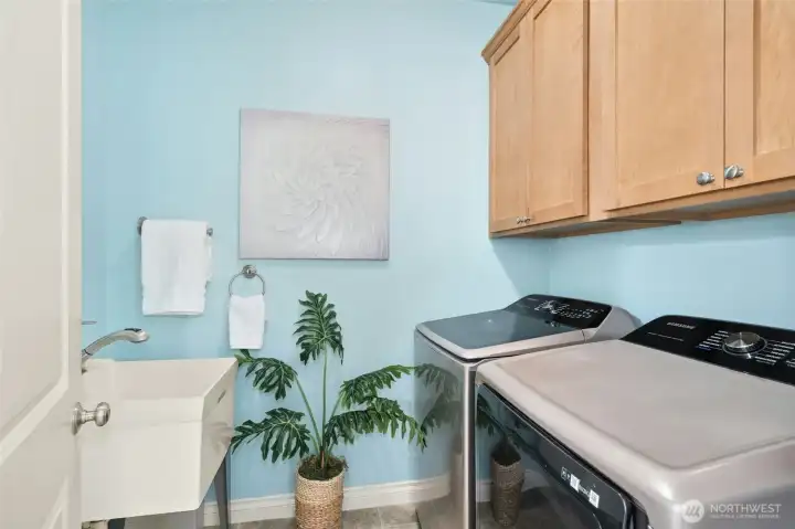 Utility room with cabinets and a sink.