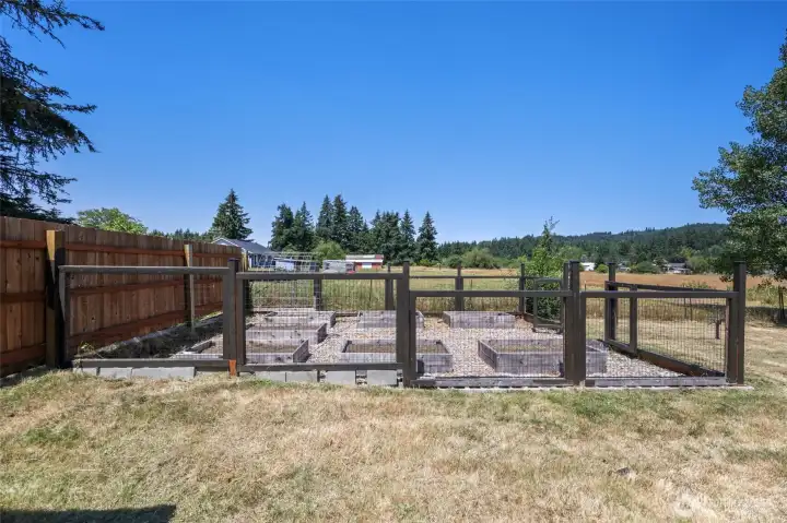 Fenced garden area with raised beds.