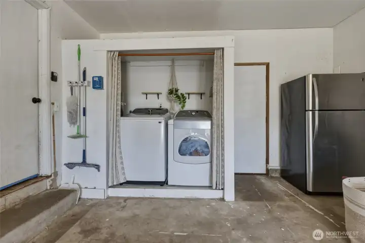 Laundry area in garage, refrigerator stays!