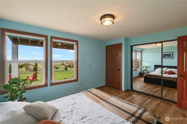 Bottom spacious bedroom with partial ocean view and private access to backyard.