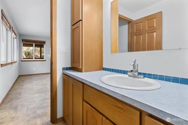 Half bathroom is conveniently located off the Family room. Plenty of storage space for your bathroom supplies. Possible linen closet?