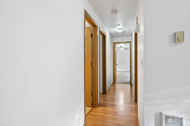 Hallway leads to three bedrooms and two full bathrooms.