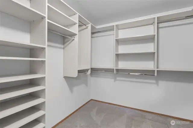 Great sized walk-in closet in the Primary Suite, complete with built-ins with rods and adjustable shelving.