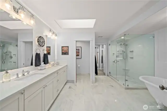 Remodeled primary bath with custom shower, claw foot tub, heated floors and mirror backlighting.